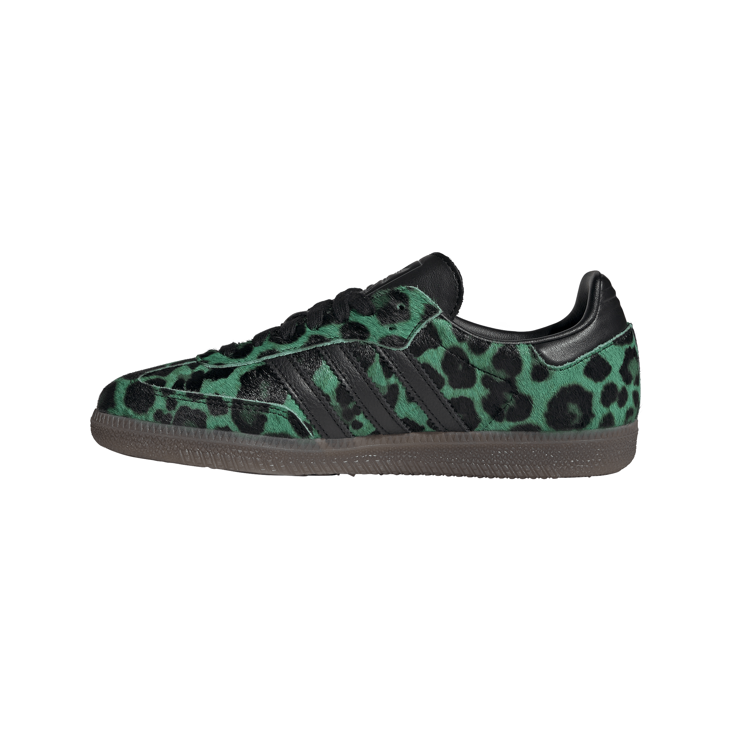 Close-up of a sneaker with green and black leopard-print fabric and black laces, brown sole visible at the bottom edge