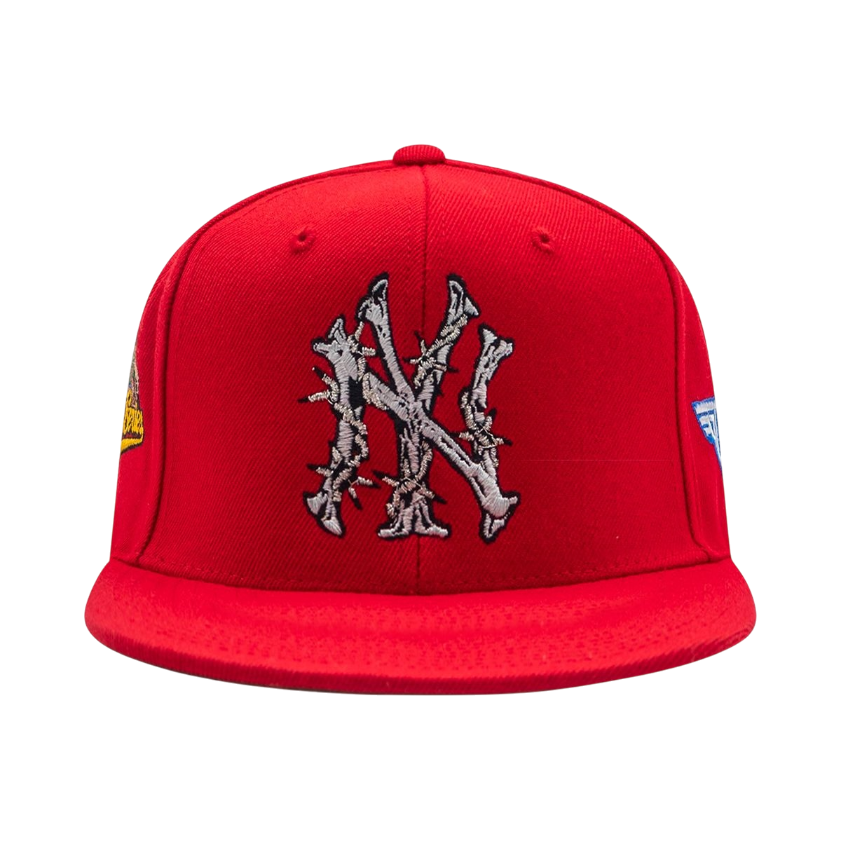 Red baseball cap featuring a gray barbed-wire NY monogram embroidered on the front and patches on the sides.