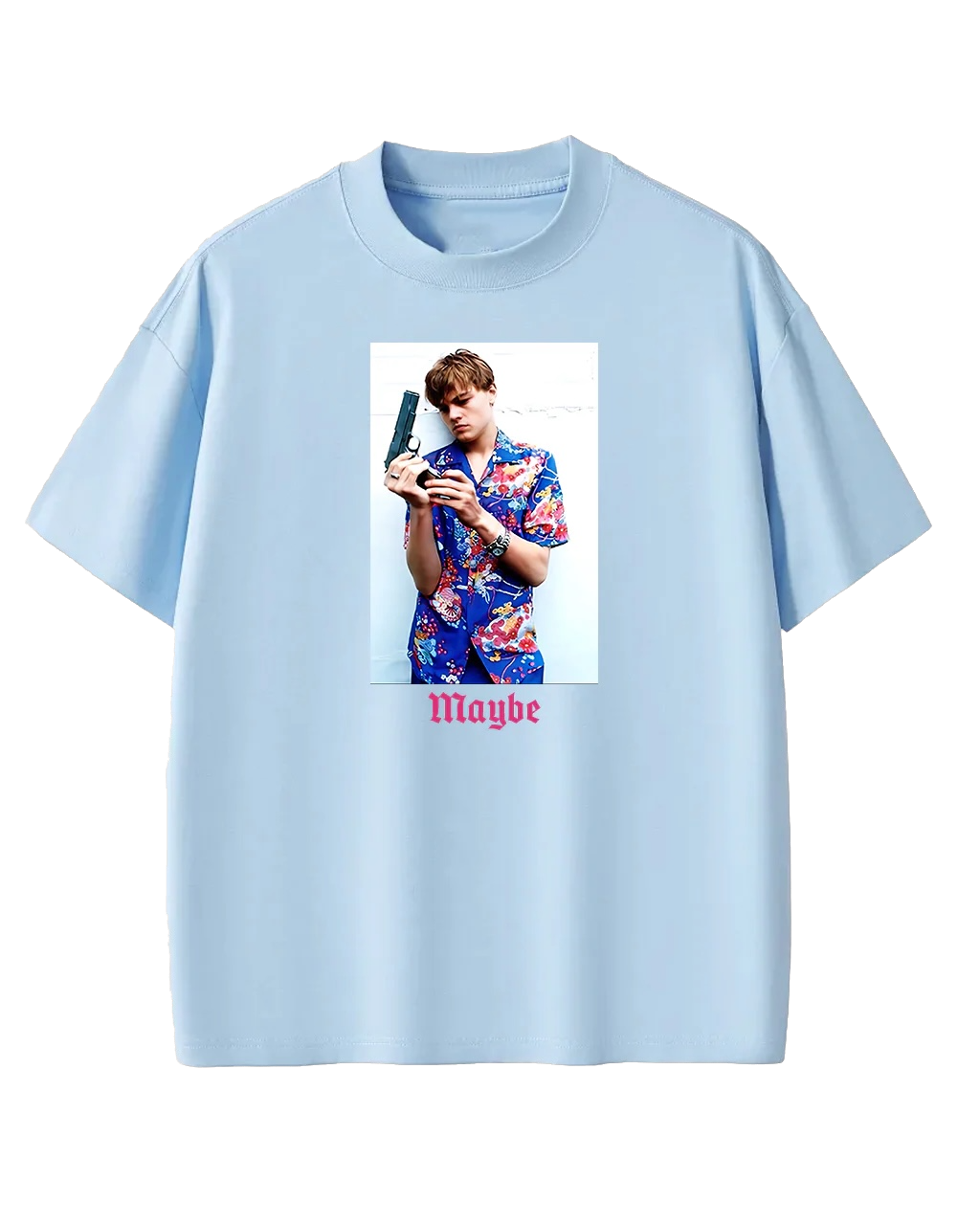 Light-blue T-shirt featuring a vertical photo of a man in a bright floral shirt holding a handgun, with the word 'Maybe' in pink gothic font underneath.